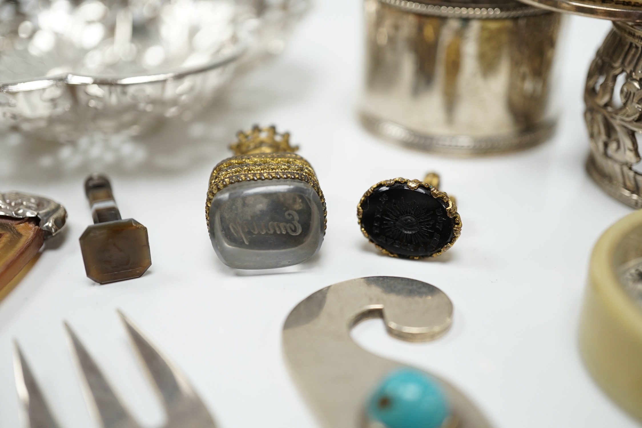 A group of assorted small silver and white metal items, including a small late Victorian clover shaped nut dish, napkin rings, pill box, etc and other items including two gilt metal mounted chalcedony fob seals.